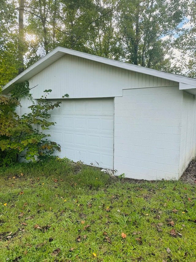 view of property exterior featuring a garage and an outdoor structure