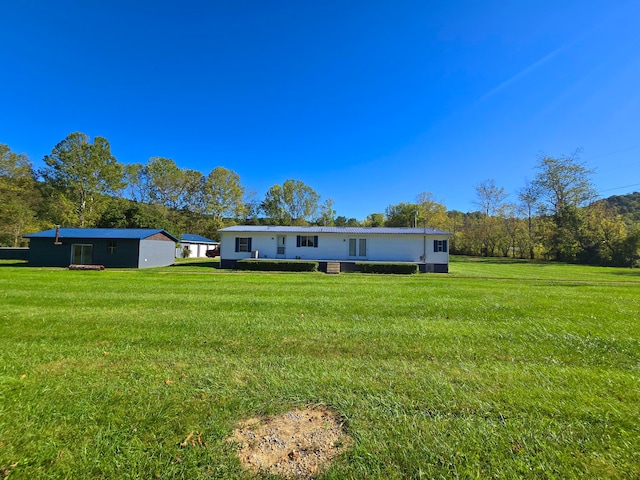 back of house with a lawn