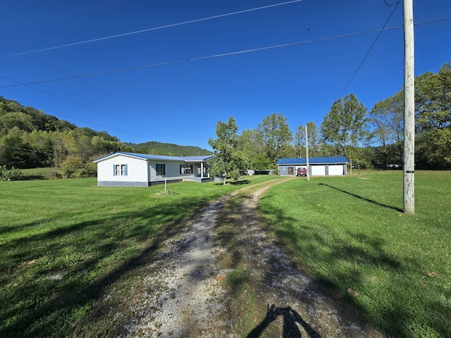 163 Eulett Ln, Vanceburg, KY 41179 - view of grassy yard featuring driveway and a garage