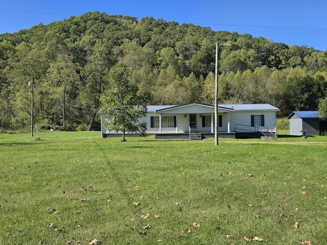 163 Eulett Ln, Vanceburg, KY 41179 - view of front of house featuring a view of trees, a front lawn, covered porch, and a metal roof