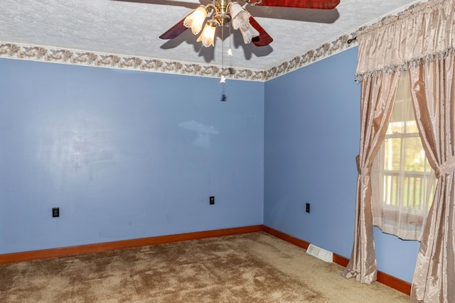 spare room with ceiling fan, a textured ceiling, and carpet floors