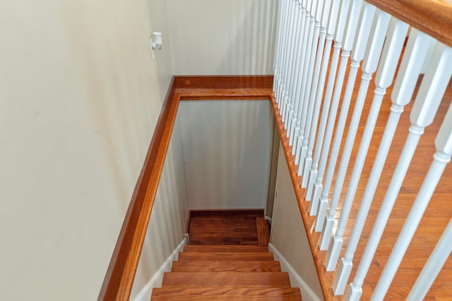 stairs featuring hardwood / wood-style floors