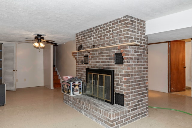 living room featuring a brick fireplace, a textured ceiling, and ceiling fan