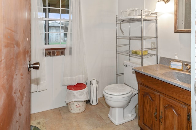 bathroom with tile patterned floors, vanity, and toilet