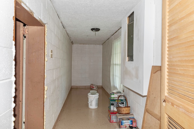 hall featuring a textured ceiling