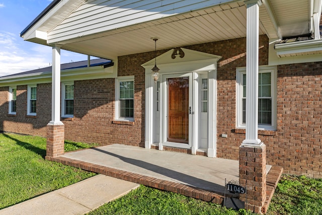 doorway to property with a yard