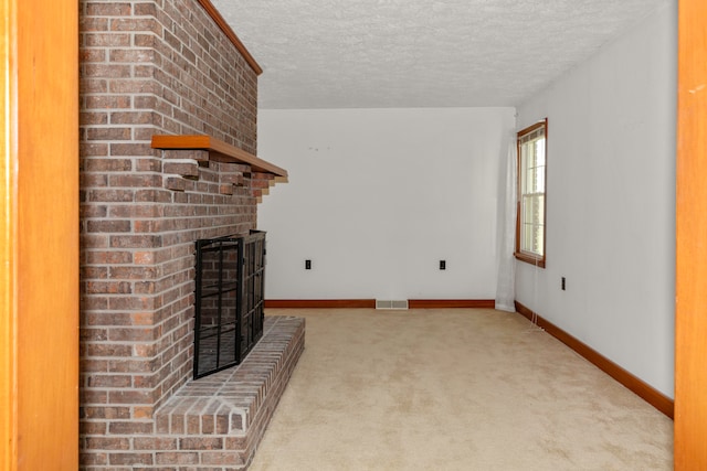 unfurnished living room featuring light carpet, a brick fireplace, and a textured ceiling