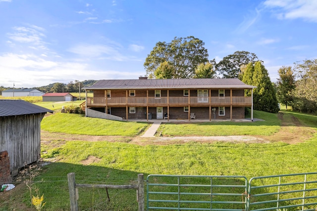 back of property featuring a lawn