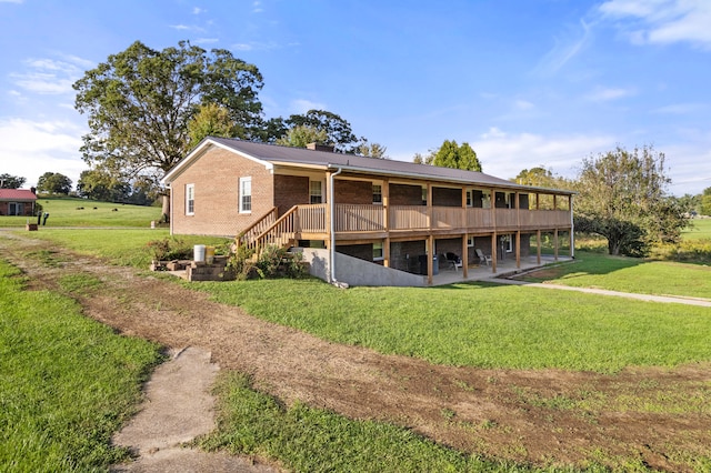 view of side of property featuring a deck and a yard