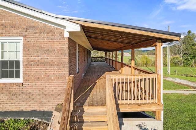 wooden terrace featuring a yard