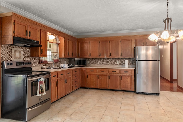 kitchen featuring decorative light fixtures, a chandelier, appliances with stainless steel finishes, crown molding, and decorative backsplash