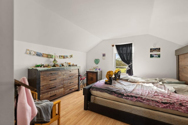 bedroom with lofted ceiling and hardwood / wood-style flooring