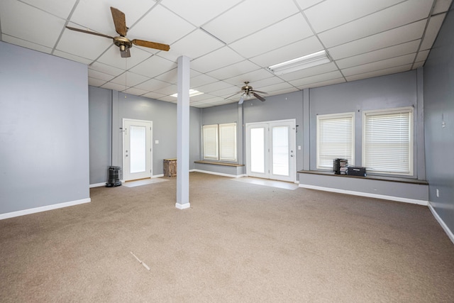 carpeted spare room with ceiling fan and a paneled ceiling