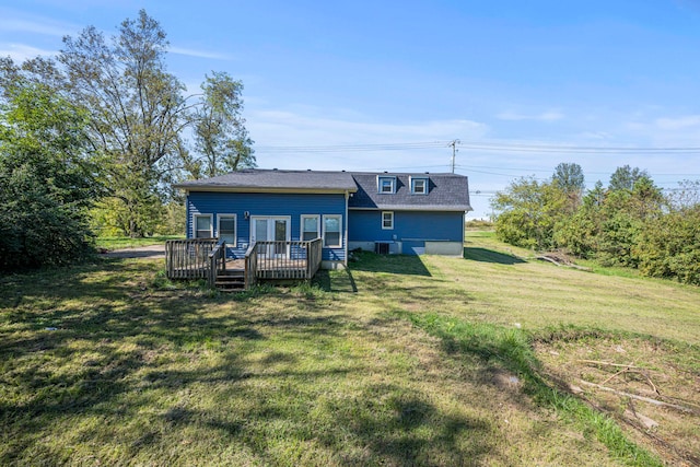 rear view of property featuring a lawn and a wooden deck