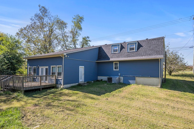 rear view of house featuring a yard, a deck, and central air condition unit