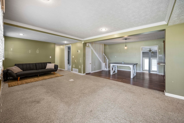 interior space featuring a textured ceiling, hardwood / wood-style flooring, ceiling fan, and crown molding