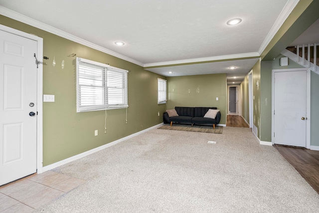 unfurnished living room featuring light carpet, a textured ceiling, and ornamental molding