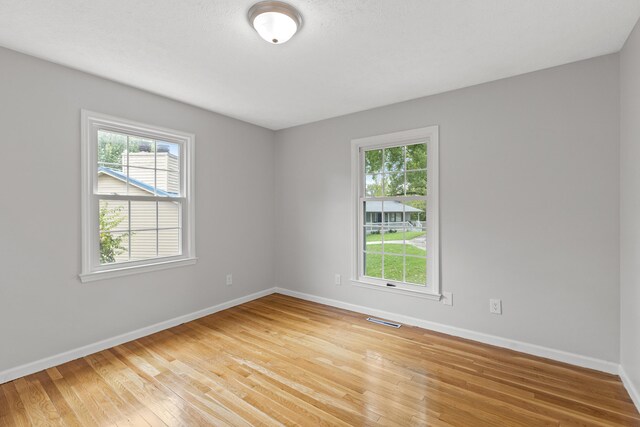 empty room with hardwood / wood-style flooring