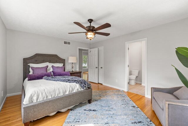 bedroom featuring light wood-type flooring, ceiling fan, and ensuite bathroom