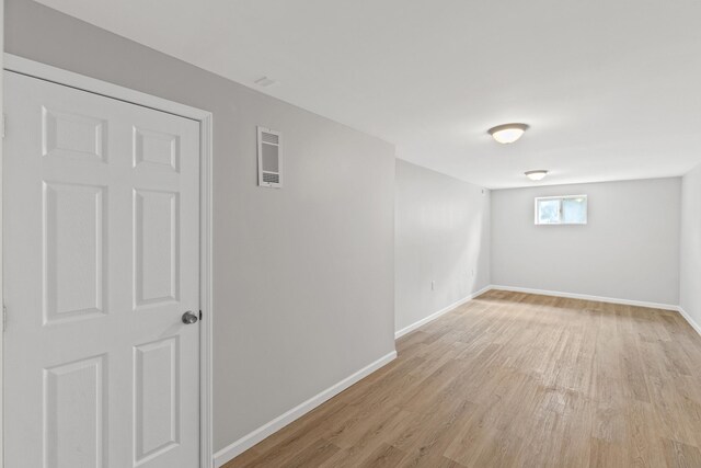 unfurnished room with light wood-type flooring