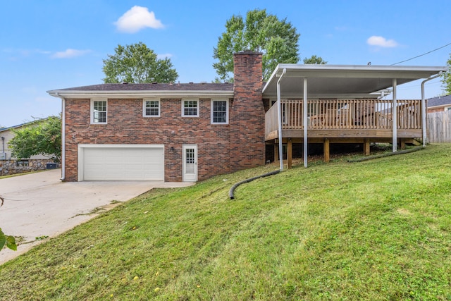 back of property with a yard, a deck, and a garage