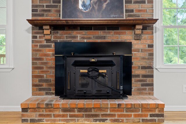 interior details featuring hardwood / wood-style floors and a wood stove