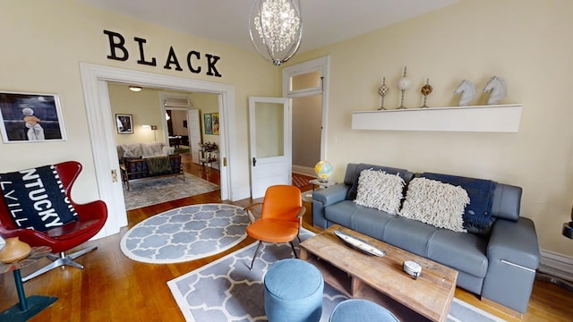 living room with hardwood / wood-style flooring and a notable chandelier