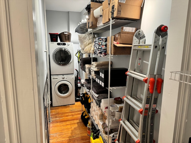 washroom featuring light hardwood / wood-style floors and stacked washer and dryer