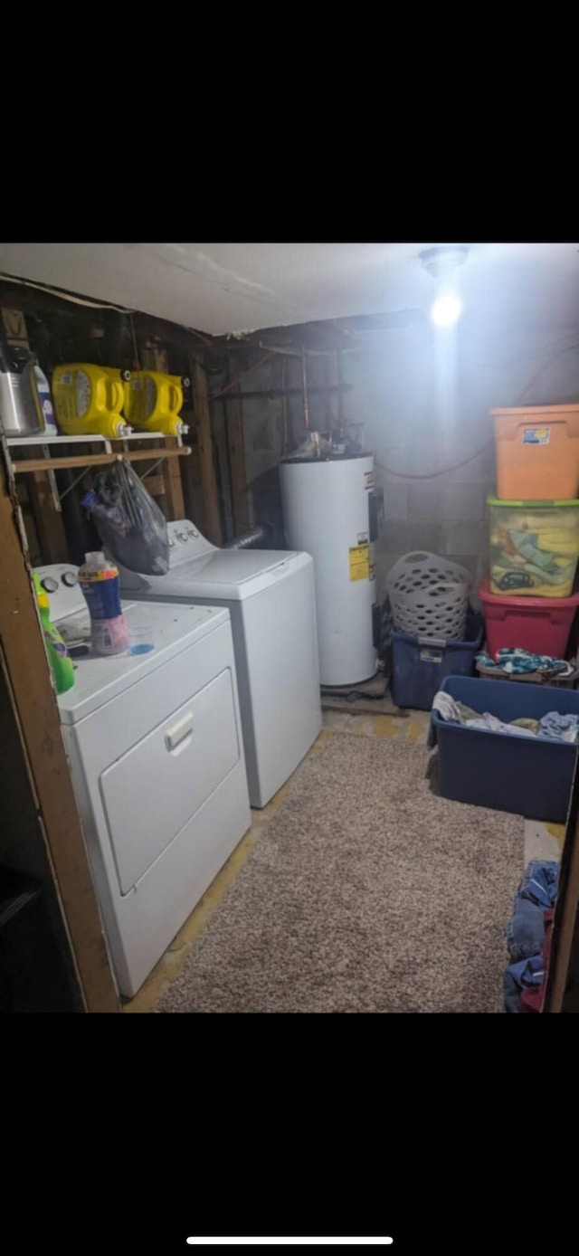 laundry room with electric water heater and washer and dryer