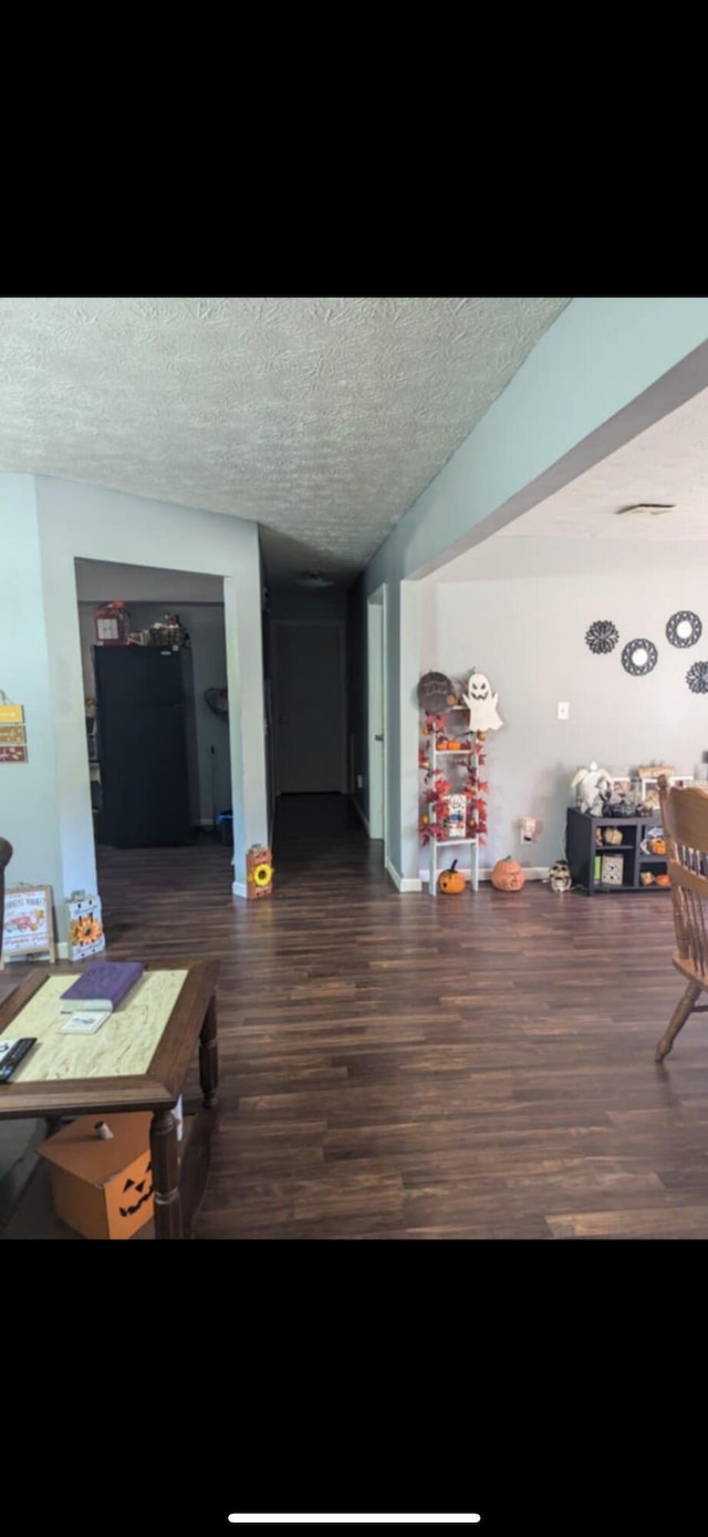 interior space featuring dark hardwood / wood-style flooring and a textured ceiling