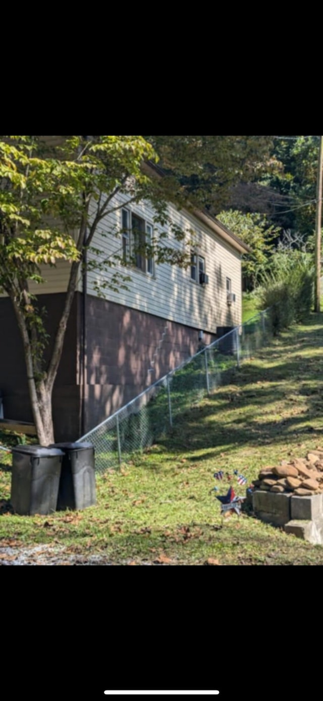 view of side of property with a lawn