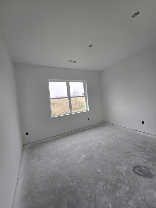 spare room with concrete floors