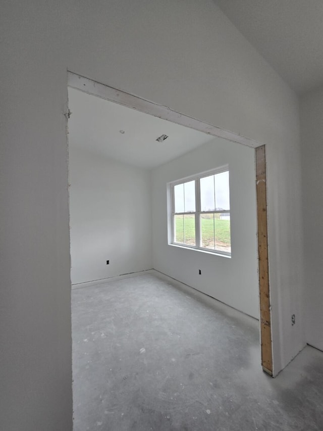 unfurnished room with concrete floors