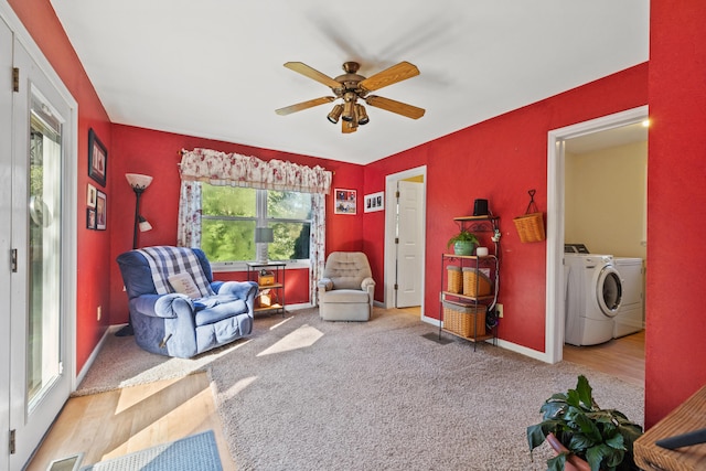 sitting room with washer and dryer, wood-type flooring, and ceiling fan