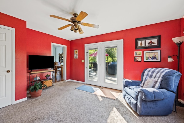 carpeted living room featuring ceiling fan