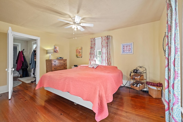 bedroom featuring dark wood-type flooring and ceiling fan