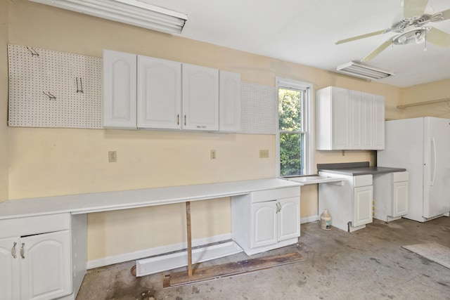 kitchen with white cabinetry, ceiling fan, and white refrigerator