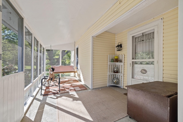 sunroom featuring vaulted ceiling