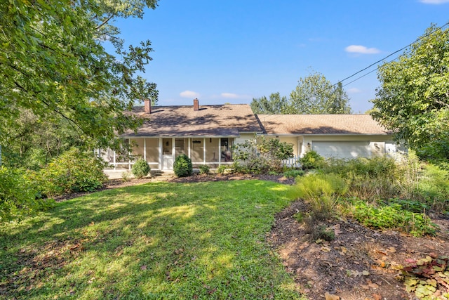 ranch-style house with a front lawn, a garage, and a sunroom