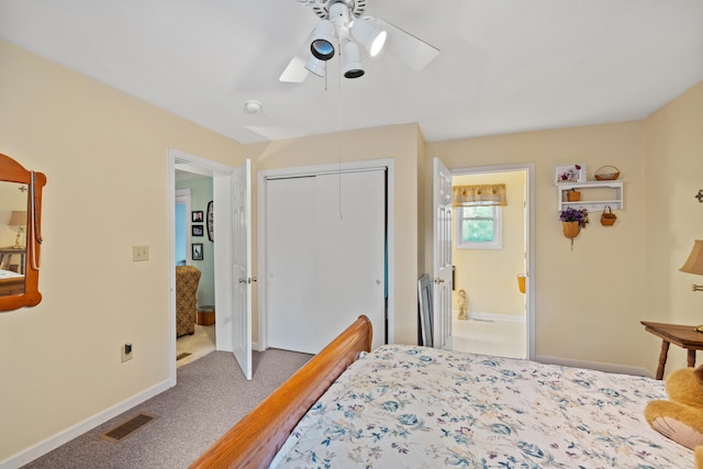 carpeted bedroom featuring a closet, connected bathroom, and ceiling fan