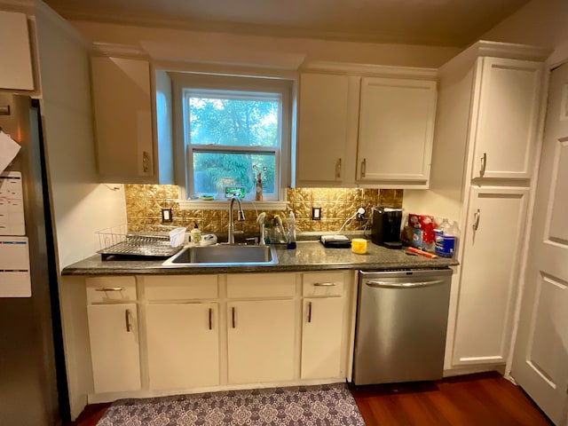 kitchen featuring white cabinets, sink, tasteful backsplash, stainless steel appliances, and dark hardwood / wood-style floors