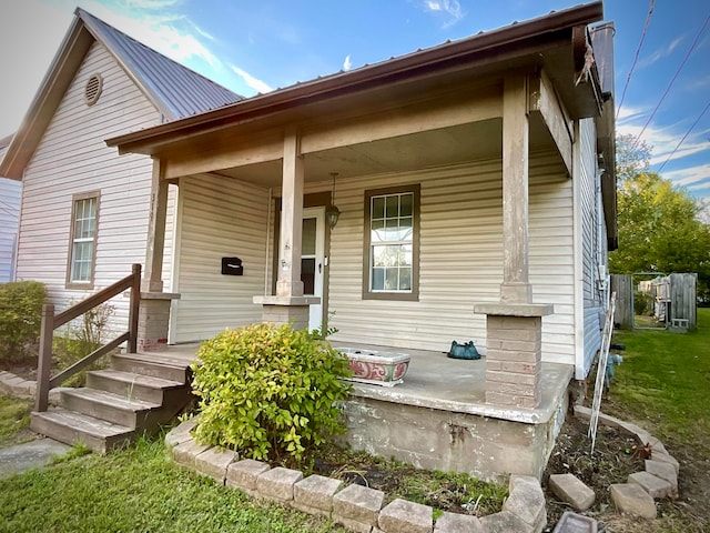 back of property with covered porch