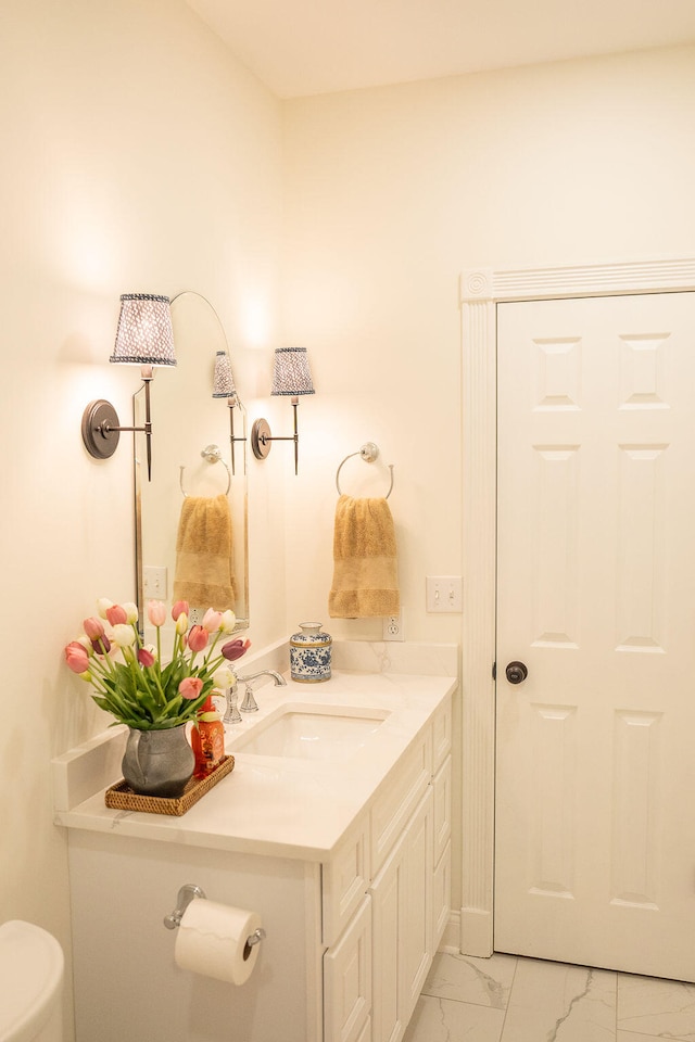 bathroom featuring vanity and toilet