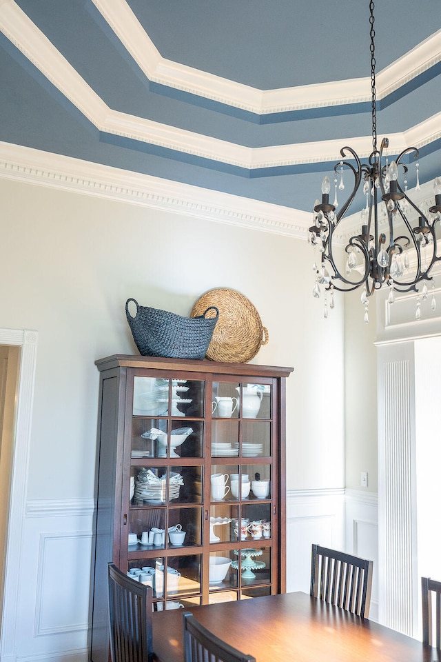 dining room with an inviting chandelier and ornamental molding