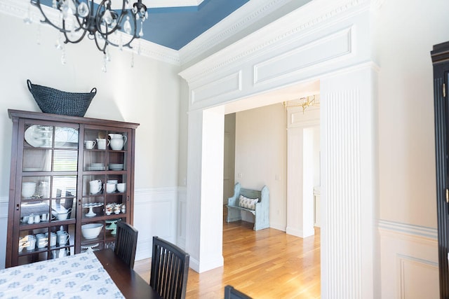 interior space with an inviting chandelier, hardwood / wood-style flooring, and crown molding