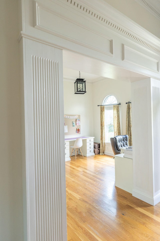 interior space featuring wood-type flooring and ornamental molding