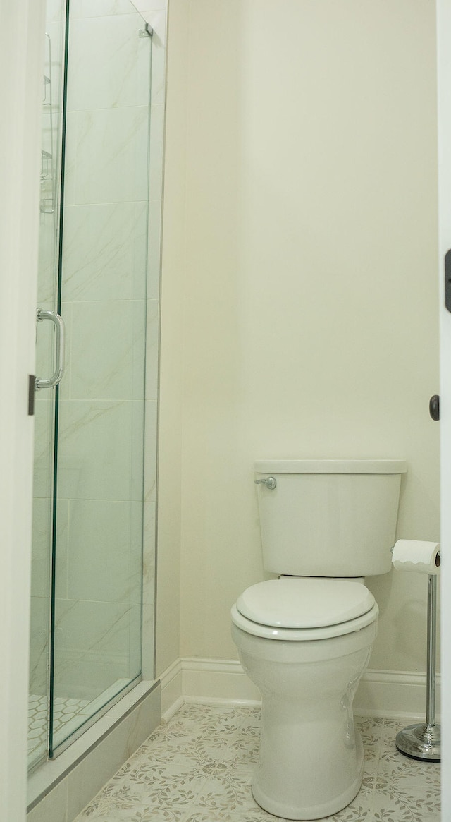 bathroom with walk in shower, toilet, and tile patterned floors