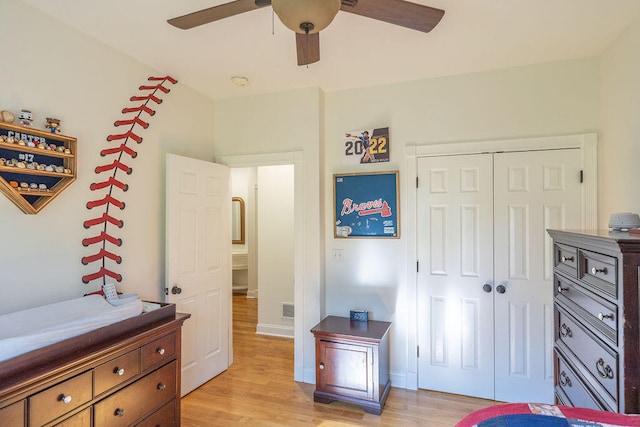 bedroom featuring ceiling fan, a closet, and light wood-type flooring