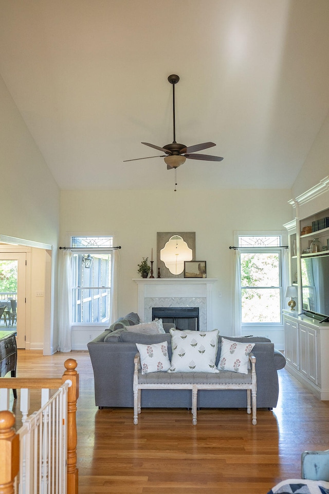 living room featuring hardwood / wood-style flooring, plenty of natural light, and high vaulted ceiling