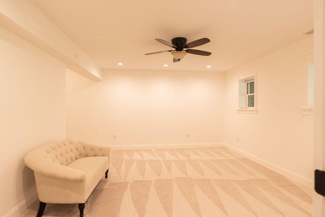 sitting room featuring carpet and ceiling fan